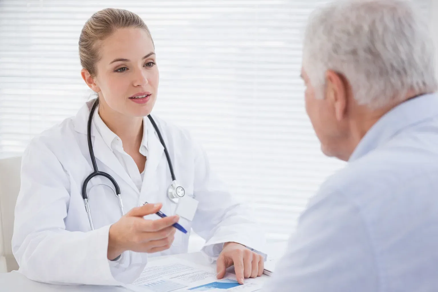 Female doctor in white coat reviewing medical charts and research papers about PFOA exposure, looking concerned in medical office